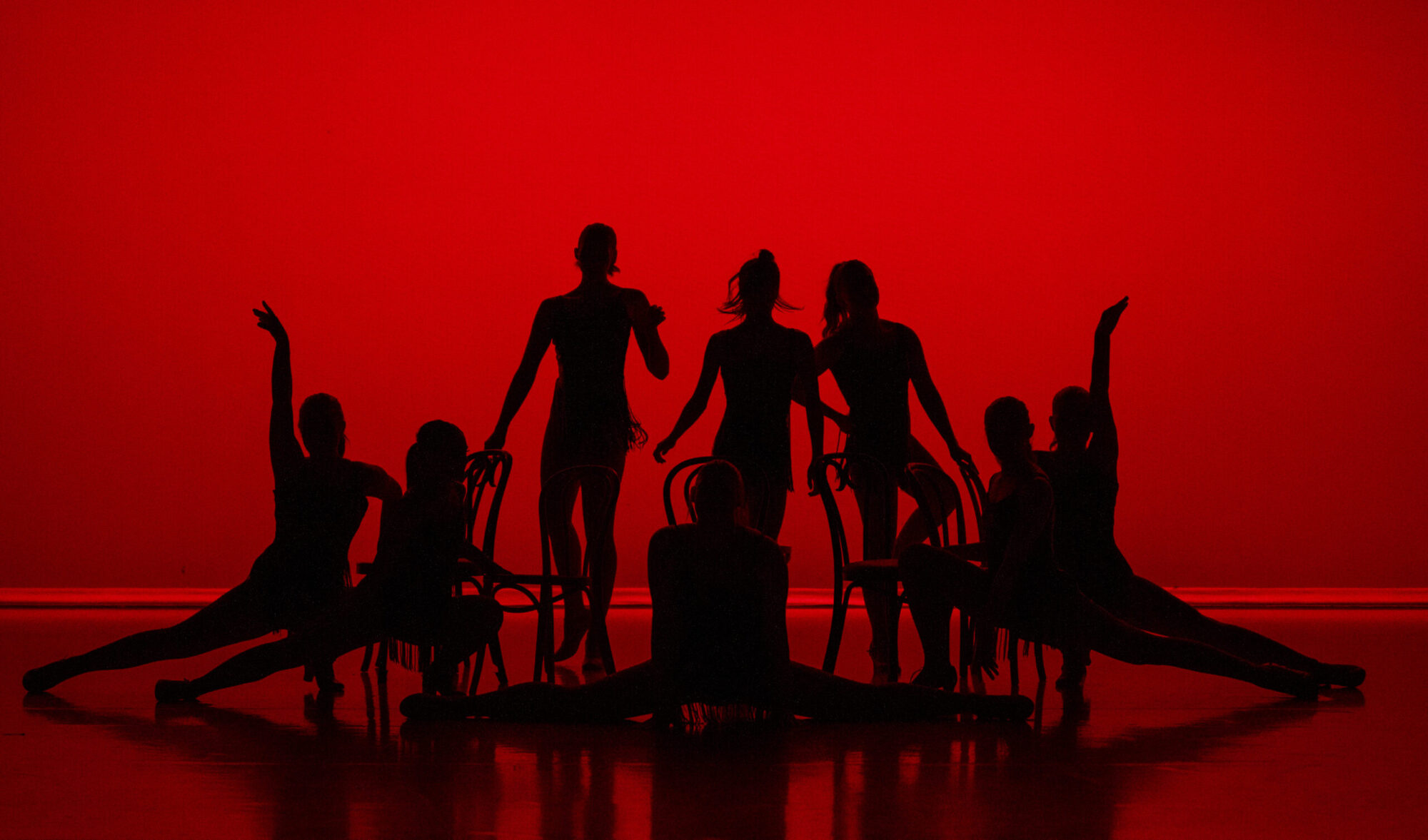 Dancers pose at the beginning of a jazz piece.